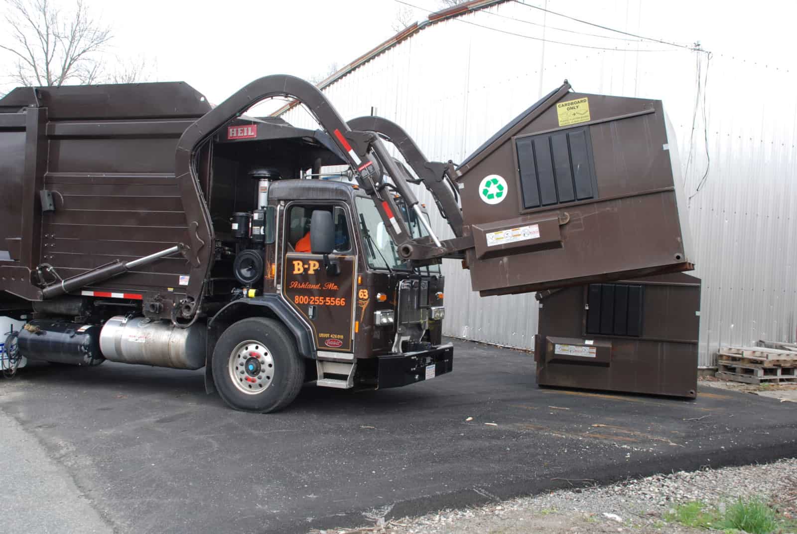 Front-Load Truck Emptying Container in Greater Boston Area